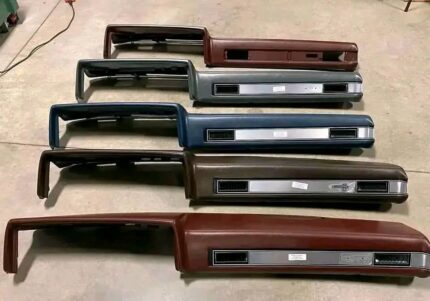 collection of dashboard pads for 1985 Chevrolet C/K series trucks. These pads, also known as dash pads, are designed to cover the dashboard and come in various colors. 
